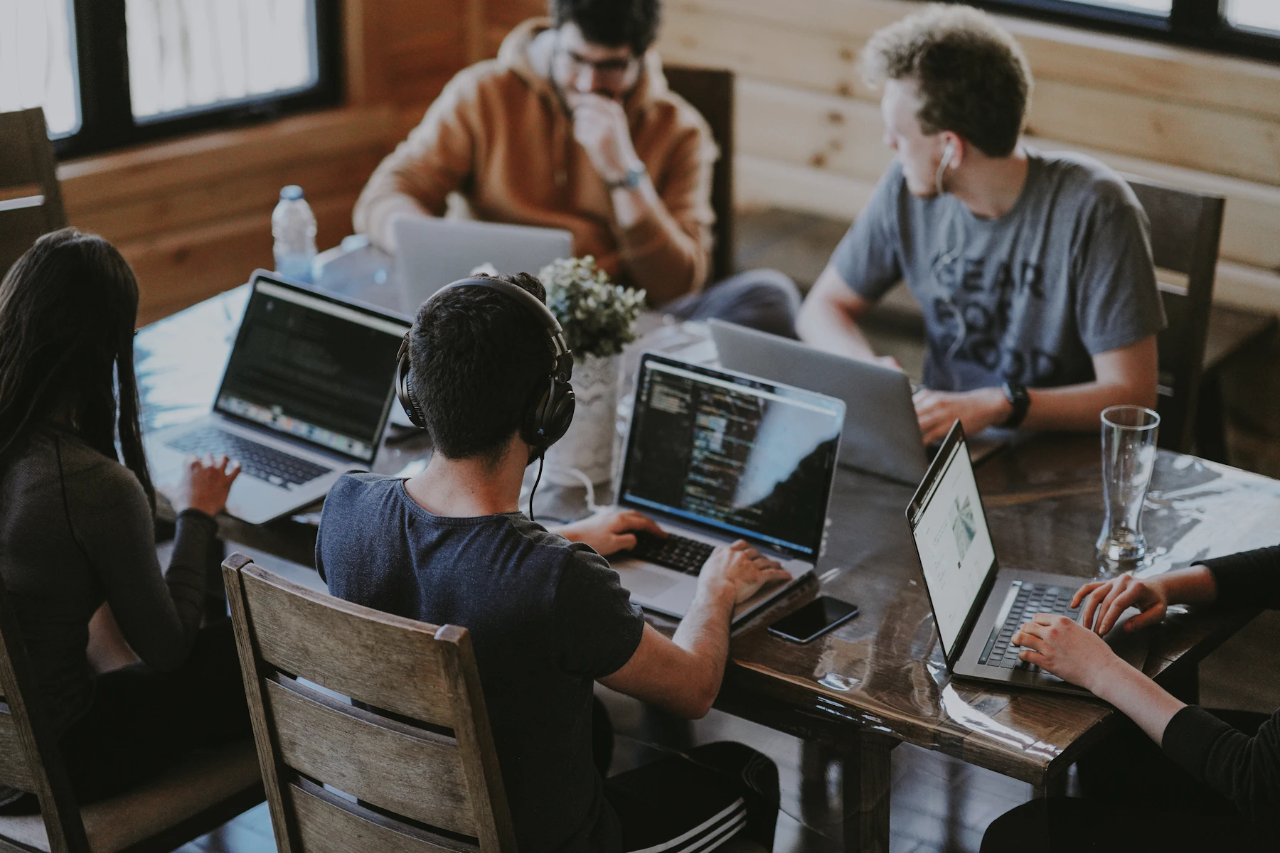 A digital team collaborating around a studio table